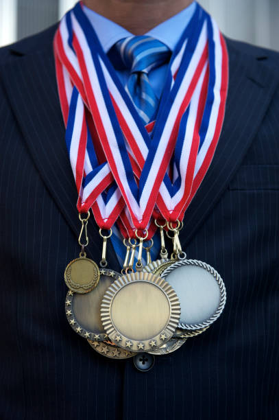 istock Businessman Stands with Medals Piled On 155146774