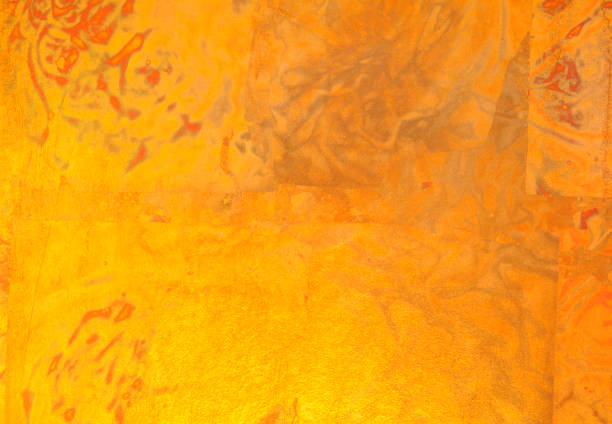 Abstract orange-golden surface, made of metal leafs. Brushed brown-golden brass or bronze surface, cloudy, wavy texture. Horizontal orientation. The photo was shot full frame and close up. Great for backgrounds use.  The dimensions of the photo are 4107 px x 2848 px.