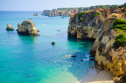 Rocky cliffs along shoreline at Lagos, Portugal in Algarve region.