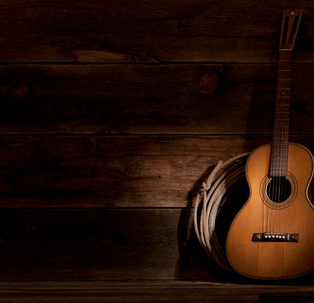 istock A guitar in the shadows, leaning against the wall 155147154