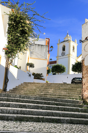 Cobblestone streets with typical Portuguese facades in Ferragudo town, Portugal