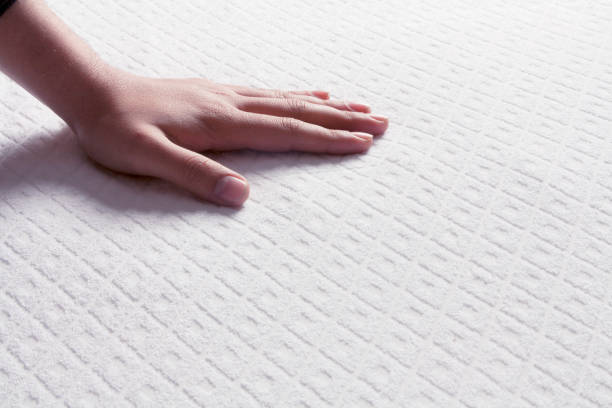 Mattresses on the human hand stock photo