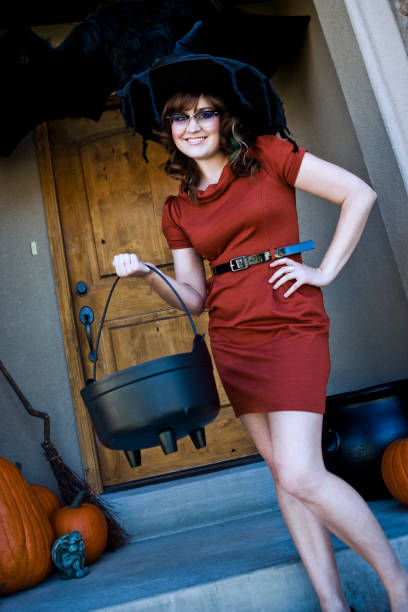 istock Beautiful Young Halloween Witch with Candy Cauldron 155147427