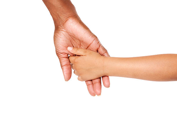 A mother and son holding hands Mother and son holding hands.  Woman is African American and the young child is Hispanic. kids holding hands stock pictures, royalty-free photos & images