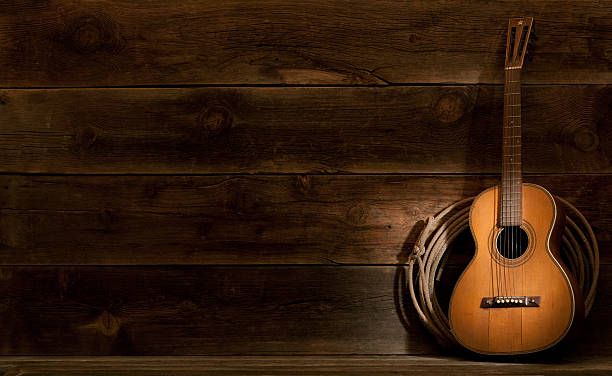 istock Western barnwood background w/parlor guitar & lasso 155147649