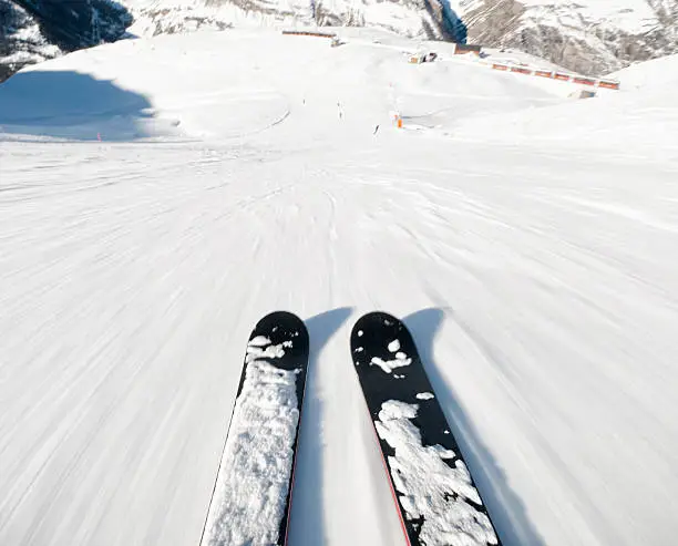 Skiing down a steep piste at high speed.