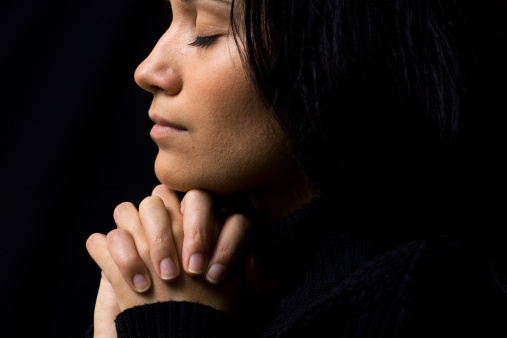 close-up of young woman praying