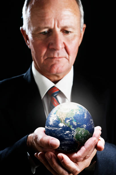 istock CEO holding miniature globe shows concern for Mother Earth 155148142