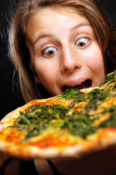 istock Girl Eating A Pizza 155148196
