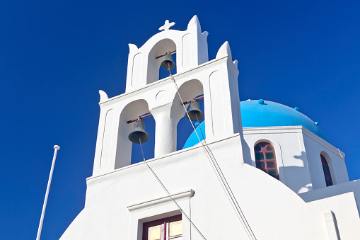 View of white, Christian, Orthodox church in the town close-up (Andros Island, Greece, Cyclades) in spring day