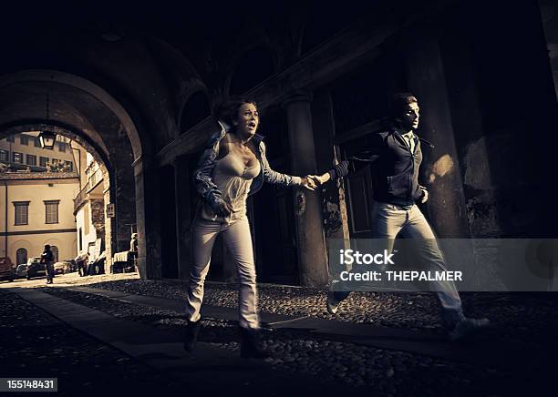 Couple Running Scare Stock Photo - Download Image Now - Running, Couple - Relationship, Fear