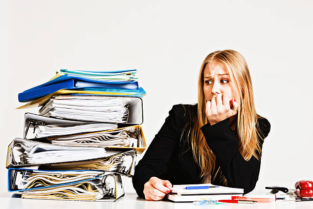 istock Blonde businesswoman bites nails worrying about work overload 155148748