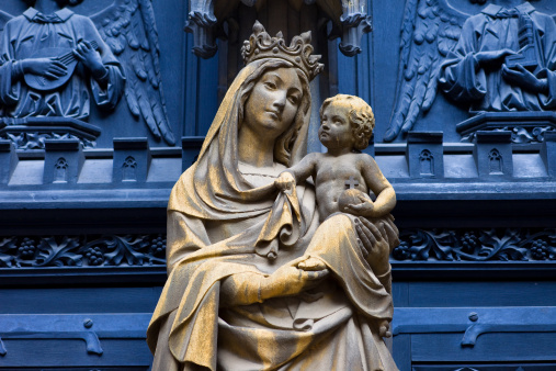 Old statue of Virgin Mary with baby Jesus outside the Dominican Church in Colmar, Alsace, France.