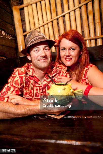 Retro Couple In Tiki Bar Stock Photo - Download Image Now - Tiki Bar, Adult, Adults Only