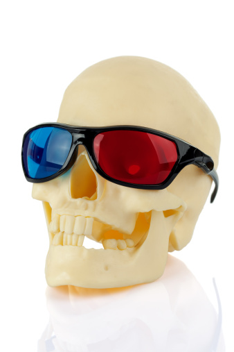 Skull wearing 3d anaglyph movie glasses. Isolated on white with clipping paths (outer and inner for teeth) 