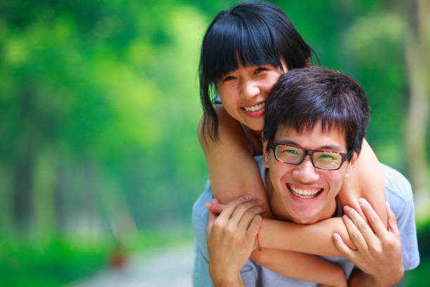 istock happy young Chinese couple in the park 155149276