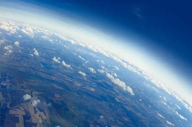 Aerial view of Planet Earth with clouds, horizon and little bit of space, make feelings of being in heaven. Cloudscape and stratosphere from above at 30000 feet.