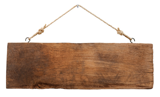 Old weathered wood signboard, hanging by old rope from a nail, isolated on white, clipping path included.
