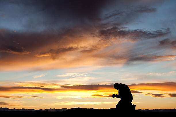 istock Silhouette of Man Praying 155149830