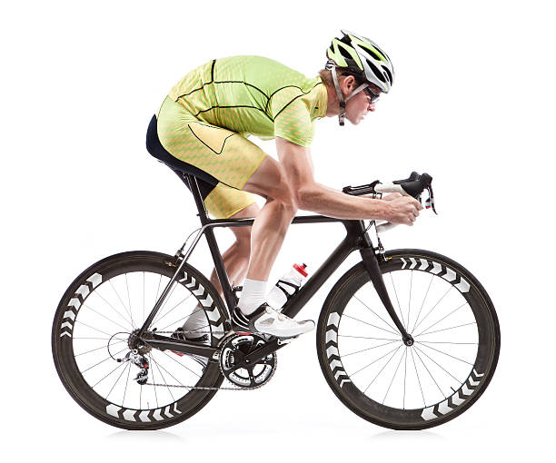 Male cyclist on road bike with white background A young man is dressed in cyclist attire, and he is riding a modern road bicycle with black-and-white tires.  The image is set on a pure white background. racing bicycle photos stock pictures, royalty-free photos & images