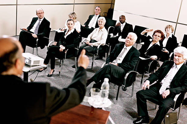 istock Business people raising hands on seminar 155150073