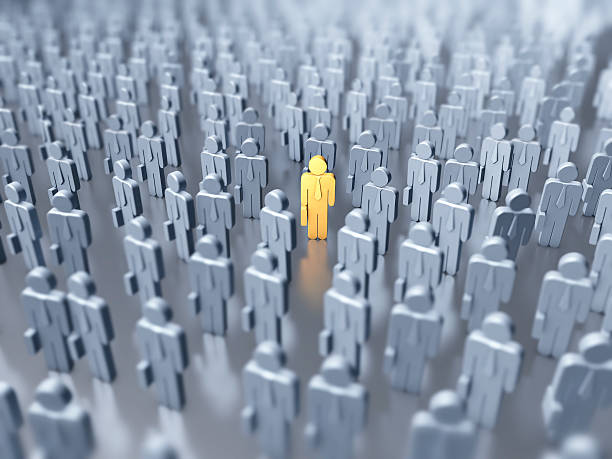 istock Numerous gray figures with one yellow figure in the middle 155150128