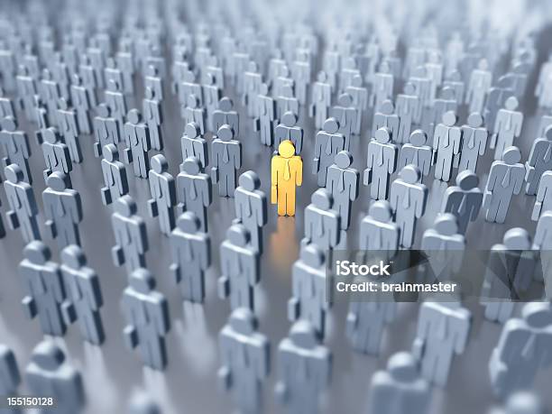 Numerous Gray Figures With One Yellow Figure In The Middle Stock Photo - Download Image Now