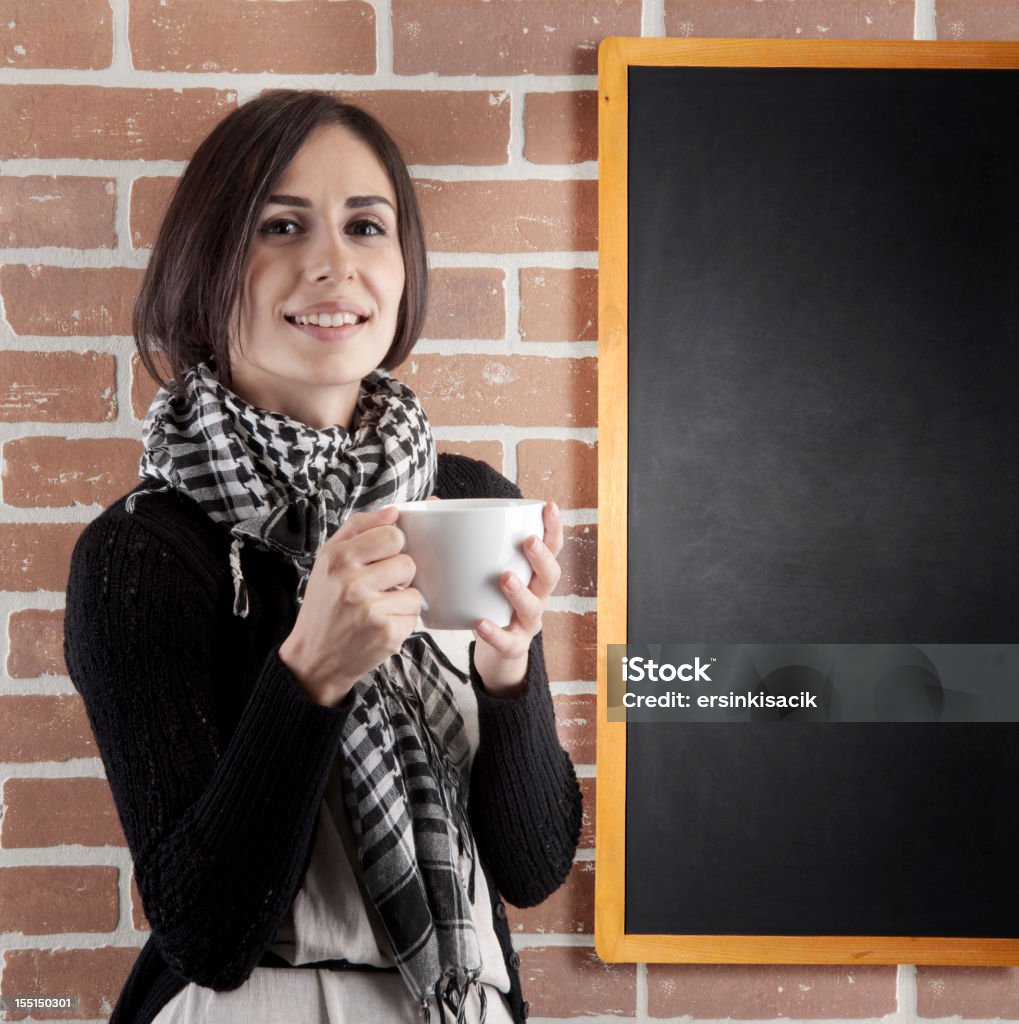 Mujer con una taza de café, cerca de la pizarra - Foto de stock de Café - Bebida libre de derechos