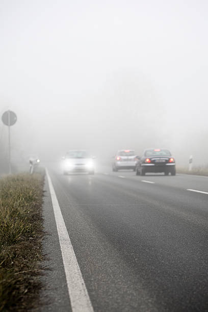 istock Dense fog on the country road, oncoming traffic 155150310