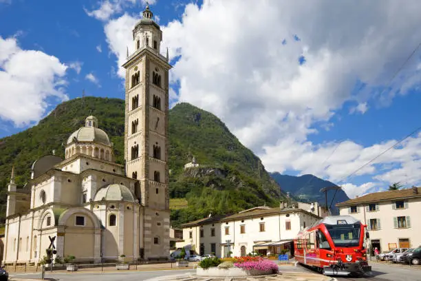 Tirano, Italy, with the Madonna di Tiranno Basilica, a major tourist attraction and pilgrimage place. Coat of arms on the train is a the coat of arms of the canton of Graubunden of Switzerland.