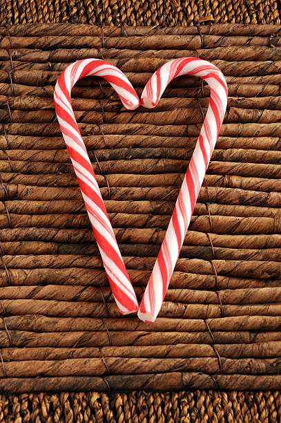 dos candy canes de navidad sobre fondo de láminas - zuckerstande fotografías e imágenes de stock