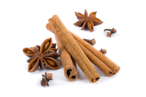 cinnamon sticks, anise and cloves on white background
