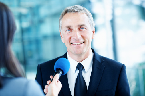 Mature male businessman giving interview to journalists.See more PEOPLE AT CONFERENCE and INTERVIEW images. For lightbox click image below.