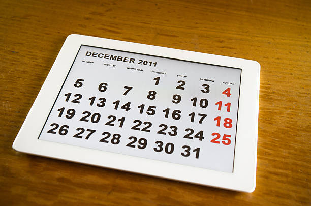 istock Digital tablet with 2011 december agenda calendar on table 155150728