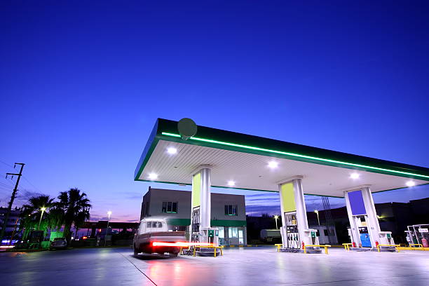 The gas station is well lit at night stock photo