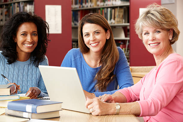istock Three women in a library working in a laptop 155150765