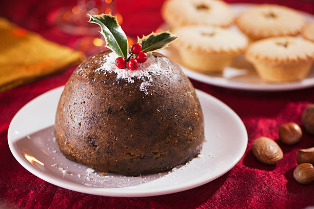 Christmas pudding on red with mince pies  christmas pudding stock pictures, royalty-free photos & images