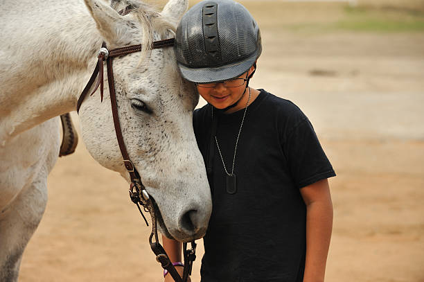 мальчик с его лошадь - horseback riding cowboy riding recreational pursuit стоковые фото и изображения