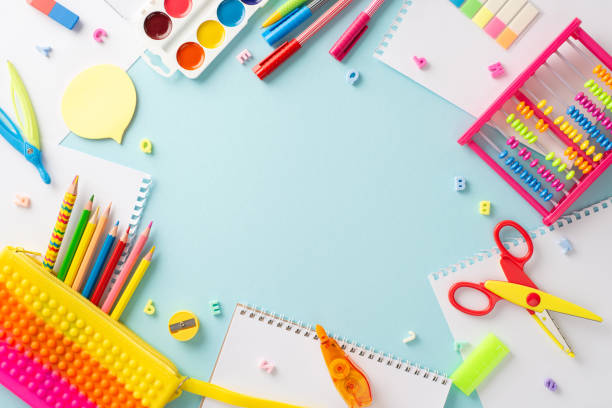 istock Discover the magic of education for small kids through this captivating top view photo: a charming display of colorful school supplies on an isolated pastel blue backdrop, ready for text or promotions 1551510325