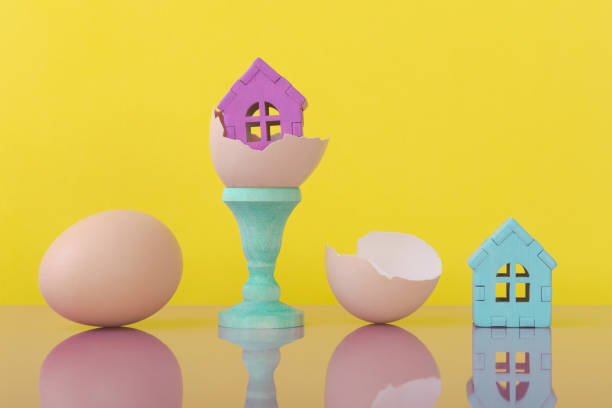 istock House models on eggshell over yellow background with copy space. New home buying 1551510348