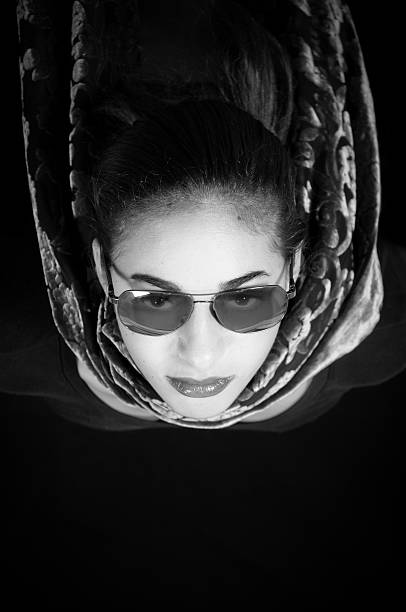 istock Young woman with sunglasses and scarf 155151152