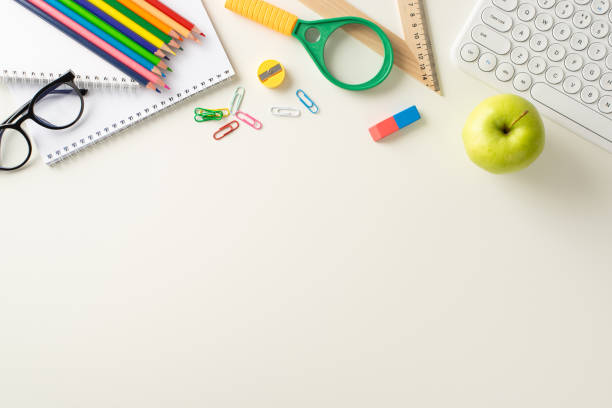istock Explore the possibilities of remote learning with this top-down snapshot displaying a keyboard, albums, office supplies on white background. Utilize the copy-space for text or advertisements 1551512969