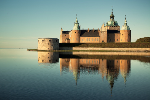 Orebro castle with a black headed gull infront on wooden jetty in Orebro Sweden may 15 2023