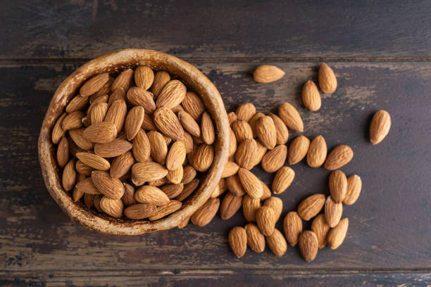 istock Organic raw almonds in bowl 1551513503