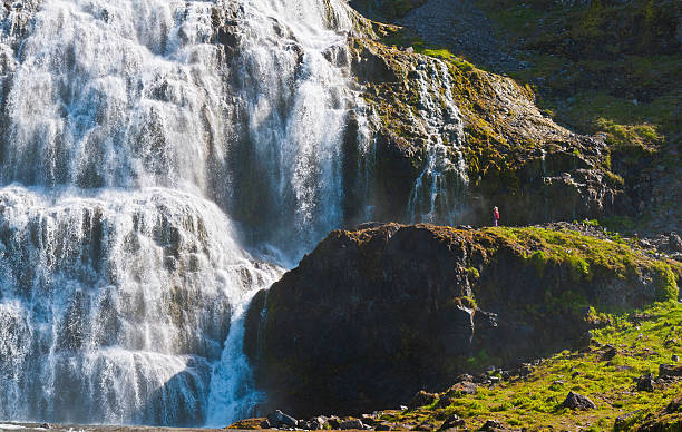 istock Child looking at huge waterfall Iceland 155151440