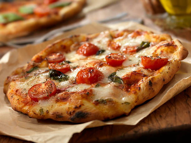Pizza Margherita Authentic Italian, Hand Made Margherita Pizza with Fresh Mozzarella,Tomatoes and Basil - Photographed on a Hasselblad H3D11-39 megapixel Camera System flatbread photos stock pictures, royalty-free photos & images