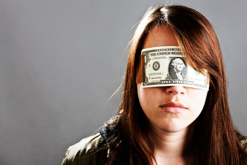 Wearing a US dollar bill as a blindfold, this young woman seems calm and accepts her situation. 