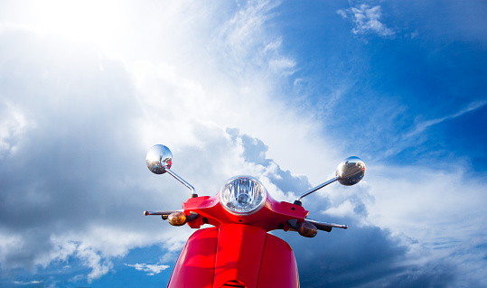 red mopedscooter and blue sky