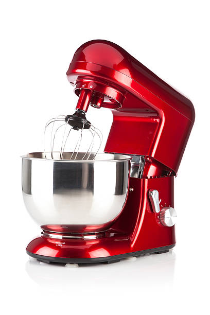 Red kitchen stand mixer shot on white backdrop Red Electric Mixer on White Background. Side View.  MORE RED HOUSEHOLD APPLIANCES ON MY PORTFOLIO http://i1215.photobucket.com/albums/cc503/carlosgawronski/HouseholdAppliances.jpg electric mixer photos stock pictures, royalty-free photos & images