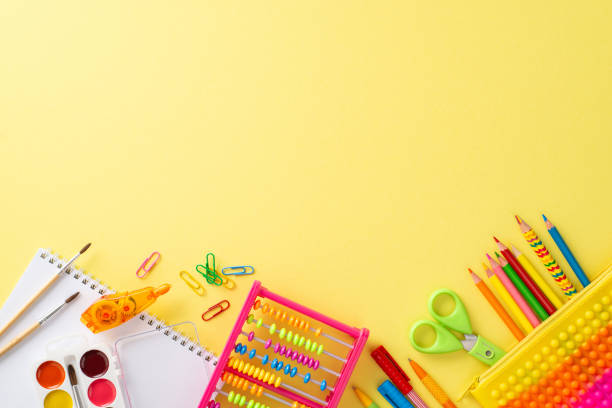 istock Step into realm of fun early education with this captivating top view composition: an array of vibrant school supplies against bright yellow background, with copyspace for text or promotional messages 1551516707